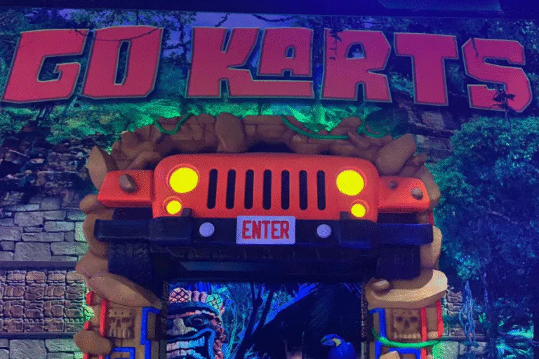 Go karts racing at The Rush Funplex, the world's largest indoor theme park, with colorful tracks and excited riders.